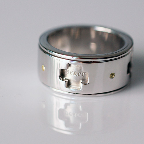 spinning wedding ring with 'peace'